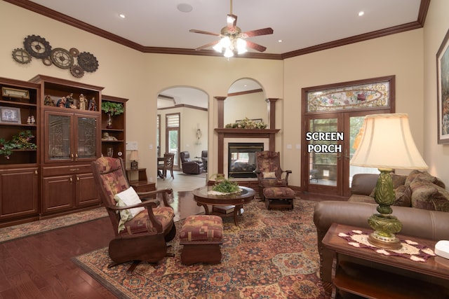 117 Hidden Shores Dr, Branson West, MO 65737 - living area featuring arched walkways, dark wood-style floors, ceiling fan, ornamental molding, and a multi sided fireplace