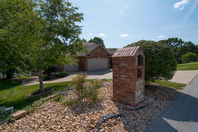 117 Hidden Shores Dr, Branson West, MO 65737 - view of front of house featuring driveway, an attached garage, a front lawn, and brick siding