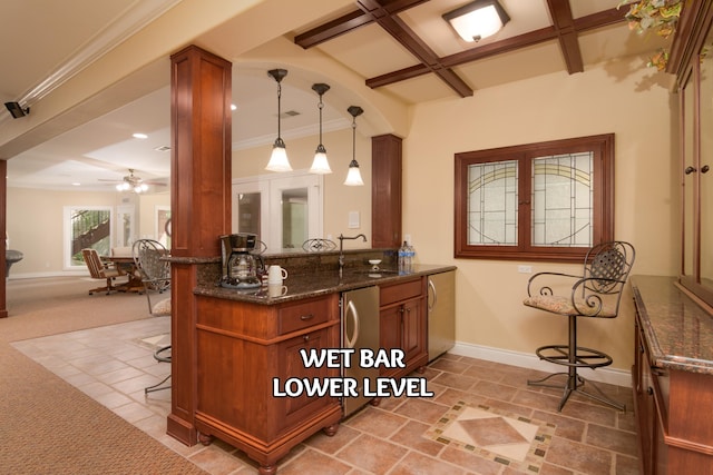117 Hidden Shores Dr, Branson West, MO 65737 - kitchen featuring coffered ceiling, a breakfast bar area, dark stone countertops, baseboards, and brown cabinetry