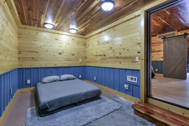 145 Allison Bnd, Lampe, MO 65681 - bedroom featuring a barn door, wood ceiling, wainscoting, and wooden walls