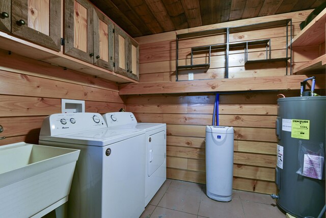 145 Allison Bnd, Lampe, MO 65681 - laundry area with water heater, washing machine and clothes dryer, cabinet space, light tile patterned floors, and wooden walls