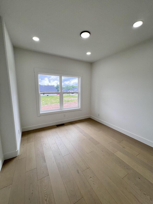 2090 N Silver Charm Ave, Springfield, MO 65802 - spare room featuring baseboards, hardwood / wood-style floors, and recessed lighting