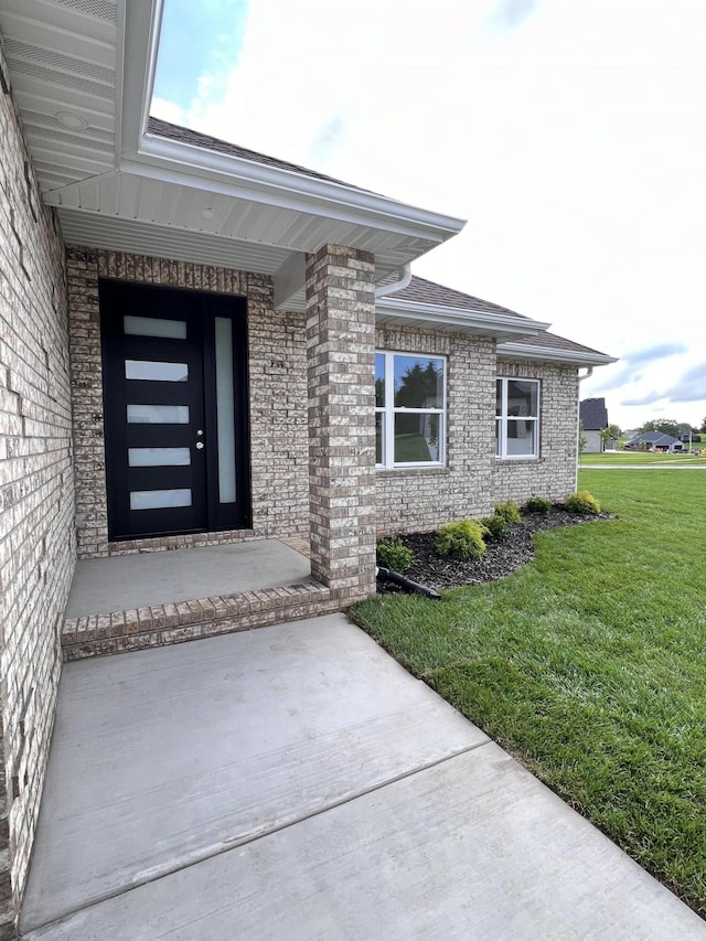 2090 N Silver Charm Ave, Springfield, MO 65802 - property entrance featuring a yard and brick siding