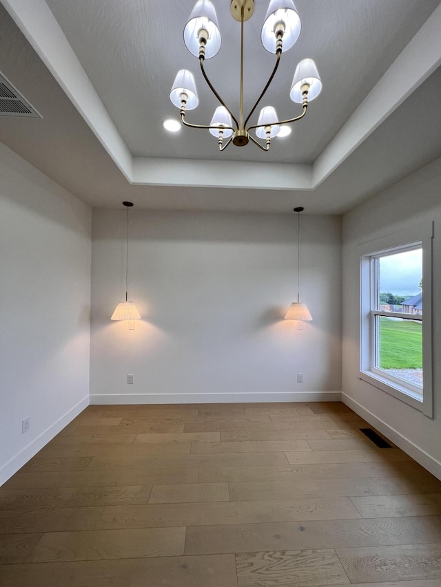 2090 N Silver Charm Ave, Springfield, MO 65802 - empty room with a raised ceiling, a chandelier, baseboards, hardwood / wood-style floors, and recessed lighting