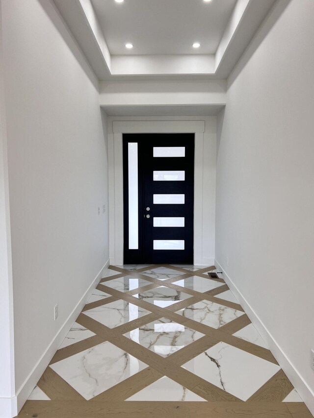 2090 N Silver Charm Ave, Springfield, MO 65802 - foyer entrance with inlaid floor details, baseboards, recessed lighting, and a tray ceiling