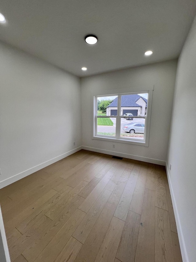2090 N Silver Charm Ave, Springfield, MO 65802 - unfurnished room featuring baseboards, hardwood / wood-style floors, and recessed lighting