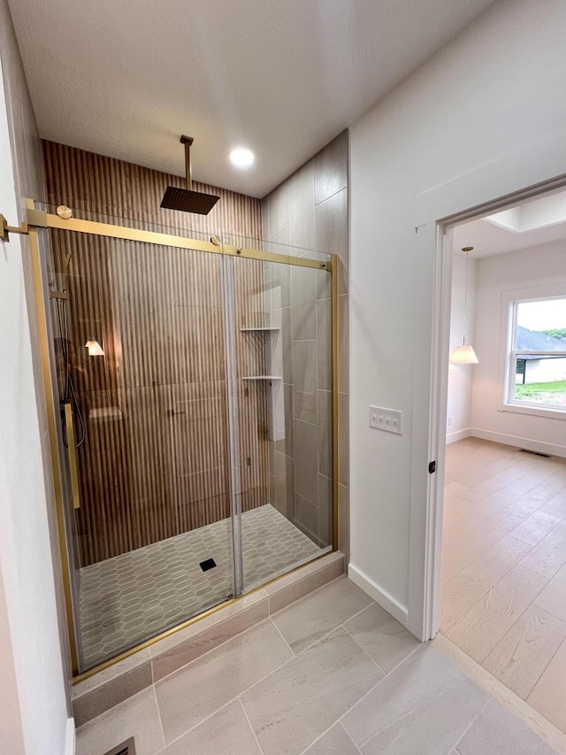 2090 N Silver Charm Ave, Springfield, MO 65802 - bathroom featuring a stall shower and baseboards