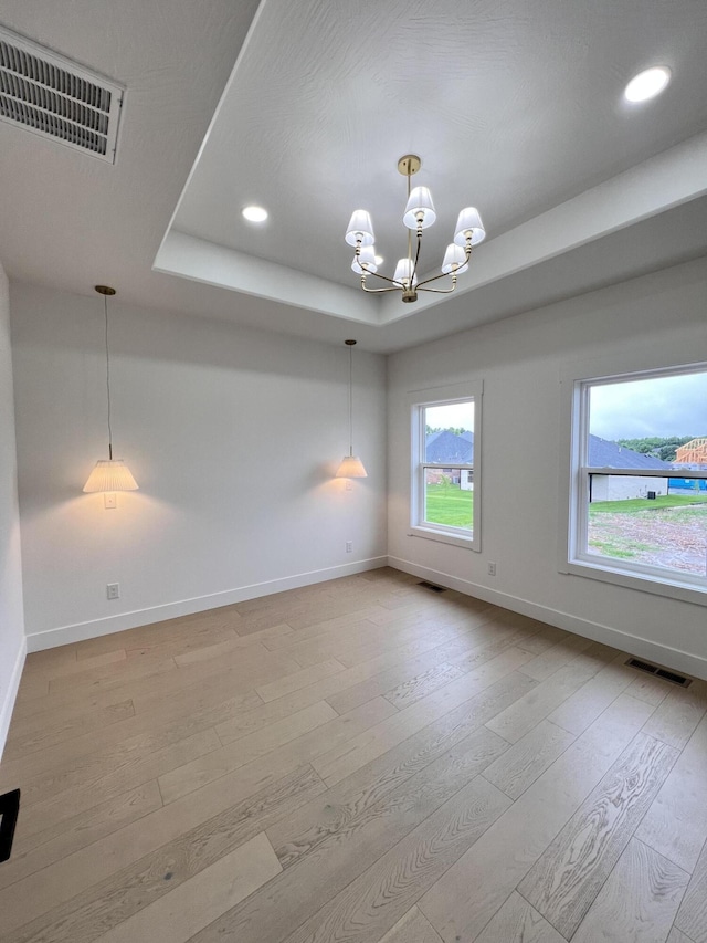 2090 N Silver Charm Ave, Springfield, MO 65802 - empty room with baseboards, a raised ceiling, light wood finished floors, a chandelier, and recessed lighting