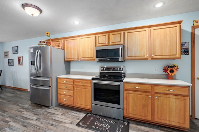 920 Bradford Ct, Marshfield, MO 65706 - kitchen featuring appliances with stainless steel finishes, wood finished floors, light countertops, and recessed lighting