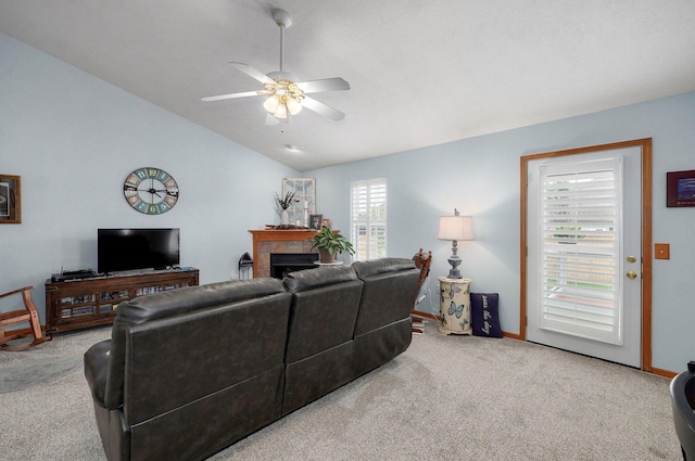 920 Bradford Ct, Marshfield, MO 65706 - carpeted living room with vaulted ceiling, ceiling fan, a tile fireplace, and baseboards
