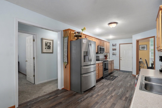 920 Bradford Ct, Marshfield, MO 65706 - kitchen with stainless steel appliances, dark wood-style flooring, baseboards, and light countertops