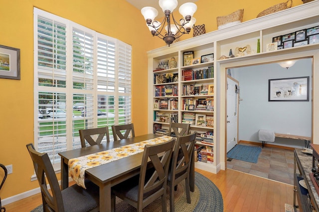 920 Bradford Ct, Marshfield, MO 65706 - dining room with a chandelier, light wood finished floors, and baseboards