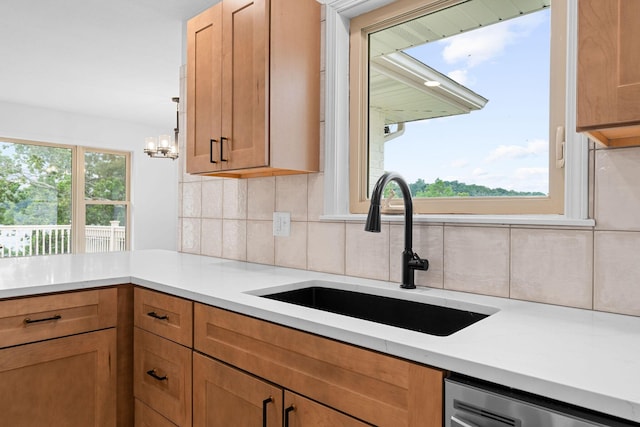 26237 Twin Rivers Dr, Shell Knob, MO 65747 - kitchen featuring a sink, dishwashing machine, tasteful backsplash, light countertops, and a chandelier