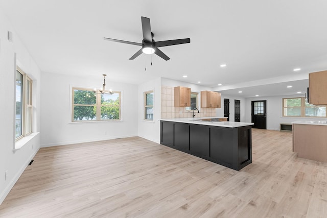 26237 Twin Rivers Dr, Shell Knob, MO 65747 - kitchen with a chandelier, light wood-type flooring, light countertops, recessed lighting, and decorative backsplash