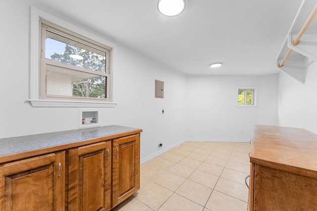 26237 Twin Rivers Dr, Shell Knob, MO 65747 - laundry room with cabinet space, electric dryer hookup, hookup for a washing machine, light tile patterned flooring, and baseboards