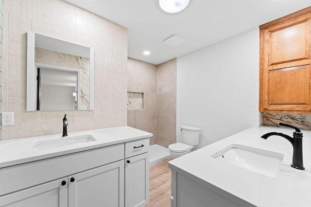 26237 Twin Rivers Dr, Shell Knob, MO 65747 - full bath featuring vanity, wood finished floors, tile walls, toilet, and decorative backsplash