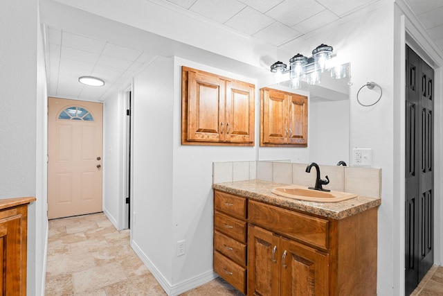 26237 Twin Rivers Dr, Shell Knob, MO 65747 - bathroom with vanity, baseboards, stone finish floors, and a paneled ceiling