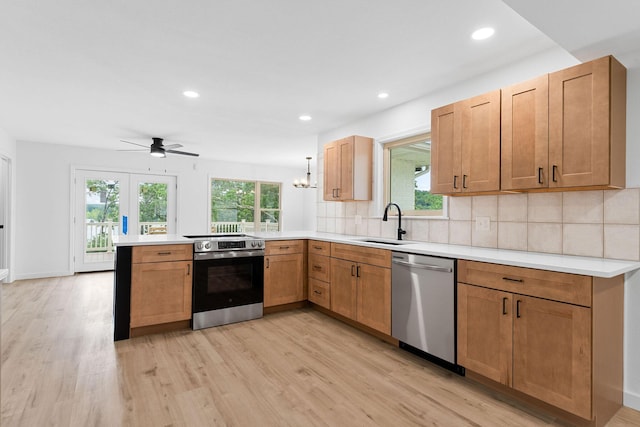 26237 Twin Rivers Dr, Shell Knob, MO 65747 - kitchen featuring stainless steel appliances, a peninsula, a sink, light wood finished floors, and recessed lighting