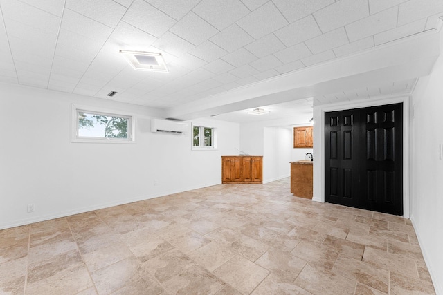 26237 Twin Rivers Dr, Shell Knob, MO 65747 - basement with an AC wall unit, baseboards, and light stone finish floors