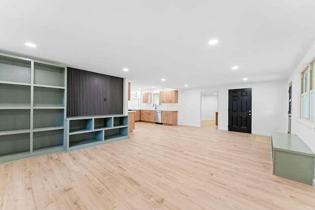 26237 Twin Rivers Dr, Shell Knob, MO 65747 - unfurnished living room featuring recessed lighting, light wood-style floors, a sink, and baseboards
