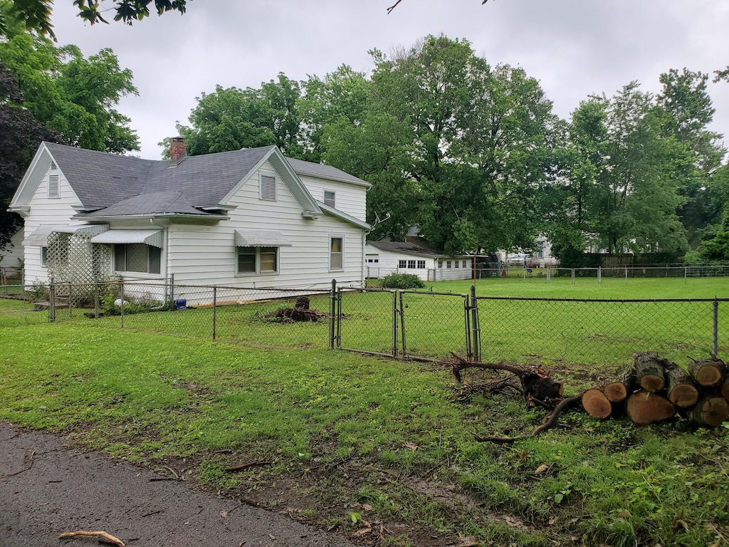 620 S Weaver Ct, Springfield, MO 65806 - view of property exterior featuring a gate, a chimney, and a shingled roof