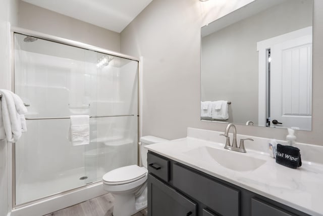 400 Lake Front Dr, Branson, MO 65616 - full bathroom with vanity, toilet, a stall shower, and wood finished floors