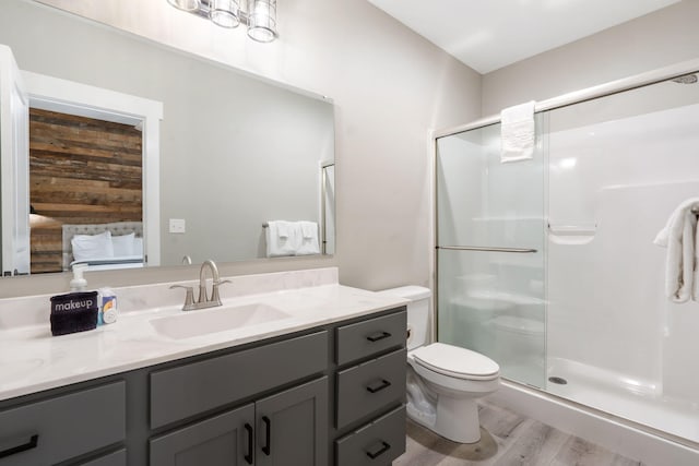 400 Lake Front Dr, Branson, MO 65616 - bathroom with vanity, a stall shower, toilet, and wood finished floors