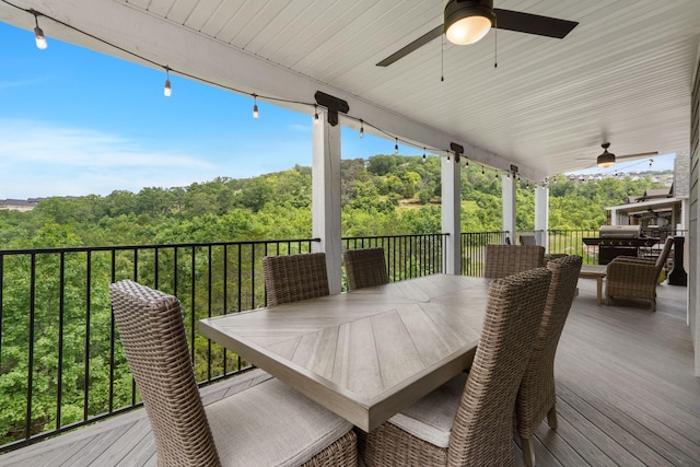 400 Lake Front Dr, Branson, MO 65616 - wooden deck with ceiling fan, outdoor dining area, and a forest view