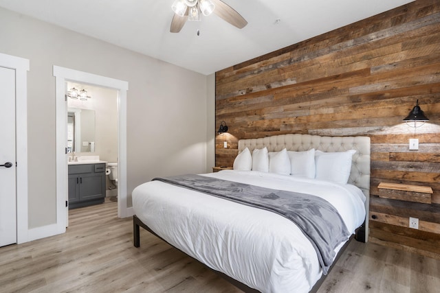 400 Lake Front Dr, Branson, MO 65616 - bedroom featuring wooden walls, light wood-type flooring, ensuite bathroom, baseboards, and ceiling fan