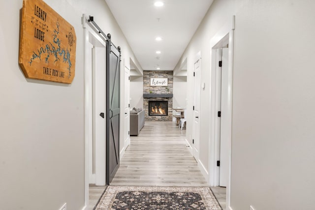 400 Lake Front Dr, Branson, MO 65616 - corridor featuring a barn door, light wood-style flooring, recessed lighting, and baseboards