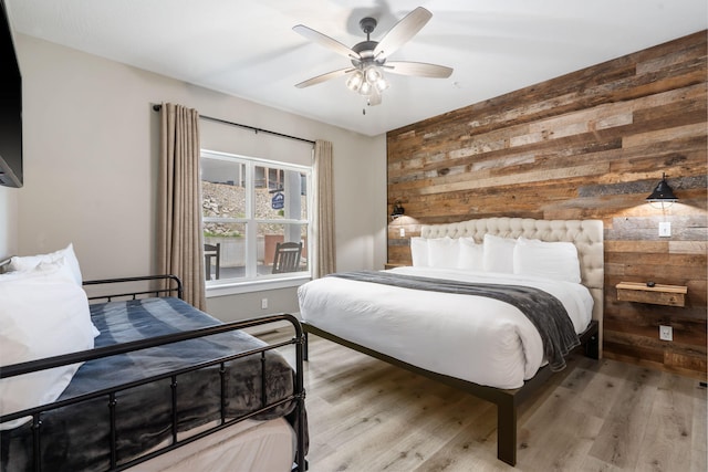 400 Lake Front Dr, Branson, MO 65616 - bedroom featuring wood walls, wood finished floors, and ceiling fan