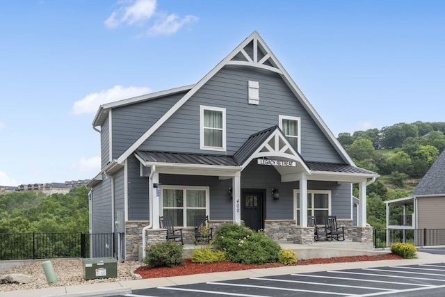 400 Lake Front Dr, Branson, MO 65616 - view of front of house featuring covered porch, uncovered parking, stone siding, and metal roof