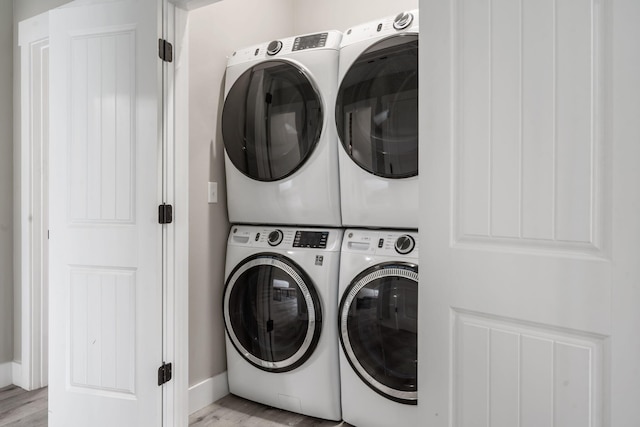 400 Lake Front Dr, Branson, MO 65616 - laundry area featuring stacked washer / drying machine, light wood-type flooring, and baseboards