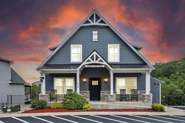 400 Lake Front Dr, Branson, MO 65616 - view of front of property with a porch, uncovered parking, stone siding, and metal roof