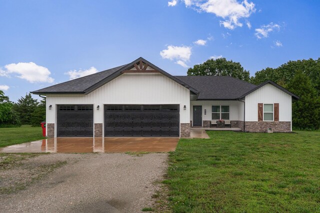 419 Wyldewood Dr, Fordland, MO 65652 - view of front of house featuring gravel driveway, a front lawn, an attached garage, and a shingled roof
