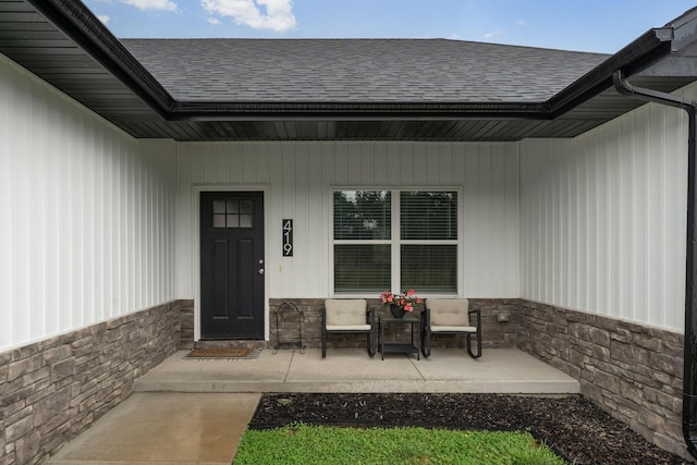 419 Wyldewood Dr, Fordland, MO 65652 - property entrance with roof with shingles, covered porch, and stone siding