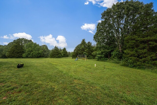419 Wyldewood Dr, Fordland, MO 65652 - view of grassy yard featuring a playground and a view of trees
