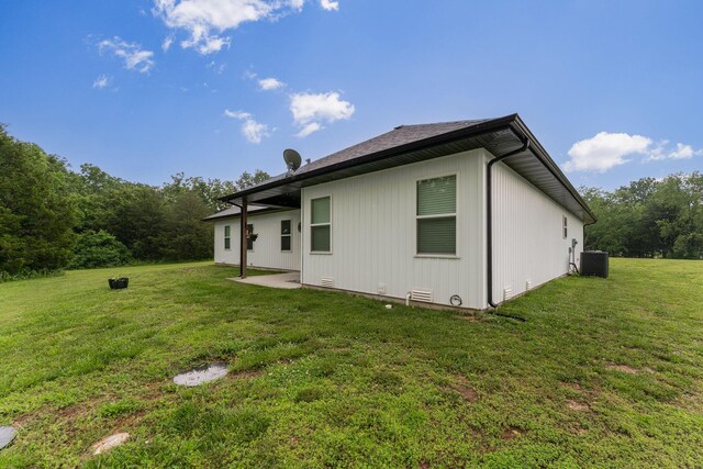 419 Wyldewood Dr, Fordland, MO 65652 - rear view of house featuring central AC unit, a lawn, and a patio area