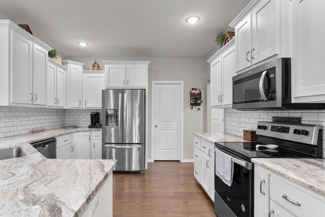 419 Wyldewood Dr, Fordland, MO 65652 - kitchen with appliances with stainless steel finishes, white cabinets, dark wood-type flooring, and recessed lighting