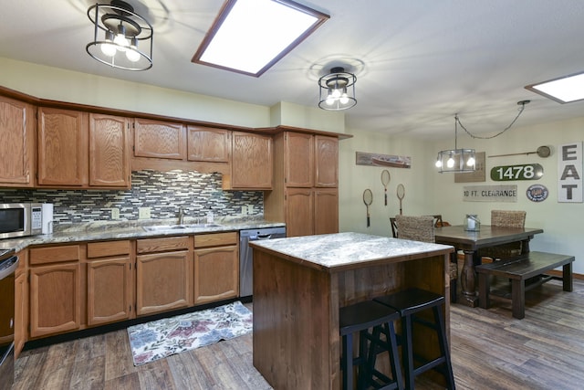 26094 State Highway 39, Shell Knob, MO 65747 - kitchen featuring stainless steel appliances, a sink, dark wood-style flooring, and brown cabinetry