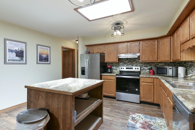 26094 State Highway 39, Shell Knob, MO 65747 - kitchen featuring stainless steel appliances, under cabinet range hood, open shelves, tasteful backsplash, and light countertops