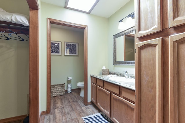 26094 State Highway 39, Shell Knob, MO 65747 - bathroom with vanity, toilet, and wood finished floors