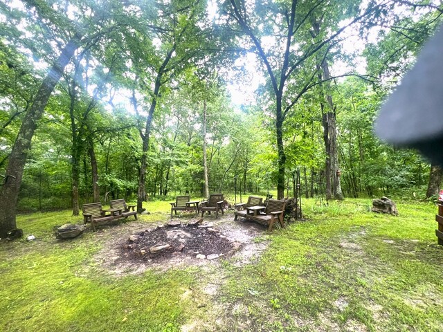 1615 E 562nd Rd, Brighton, MO 65617 - view of yard featuring an outdoor fire pit and a forest view