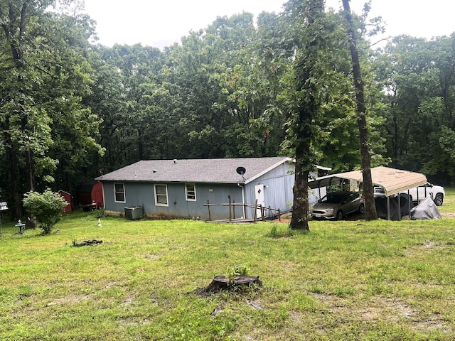 1615 E 562nd Rd, Brighton, MO 65617 - rear view of house featuring a yard, cooling unit, a view of trees, and a carport