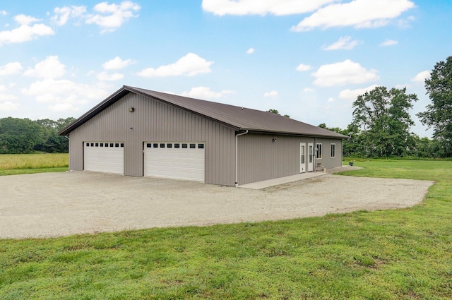 22510 Lawrence Unit 1200, Aurora, MO 65605 - view of property exterior featuring a yard, a detached garage, and metal roof