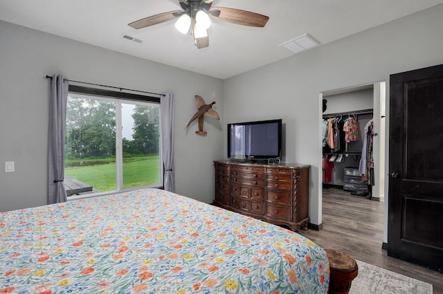 22510 Lawrence Unit 1200, Aurora, MO 65605 - bedroom featuring wood finished floors, a walk in closet, a ceiling fan, and a closet