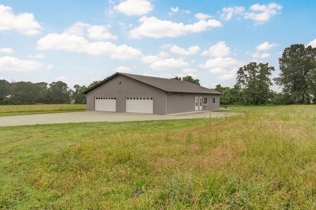 22510 Lawrence Unit 1200, Aurora, MO 65605 - view of side of home featuring metal roof, a detached garage, a lawn, and driveway