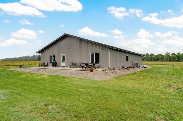 22510 Lawrence Unit 1200, Aurora, MO 65605 - rear view of property with a patio area, a lawn, and central AC unit