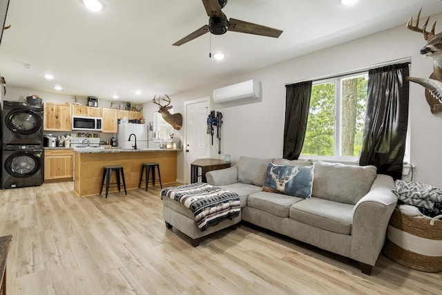 166 Seaman St, Cape Fair, MO 65624 - living room featuring estacked washer and dryer, a wall mounted air conditioner, light wood-type flooring, ceiling fan, and recessed lighting