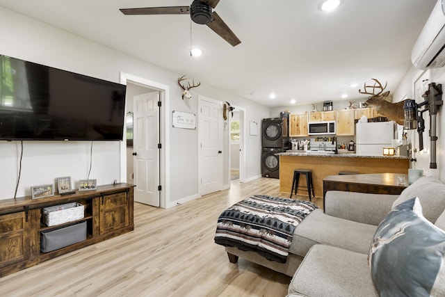 166 Seaman St, Cape Fair, MO 65624 - living area featuring stacked washing machine and dryer, a wall mounted air conditioner, light wood-style flooring, a ceiling fan, and recessed lighting